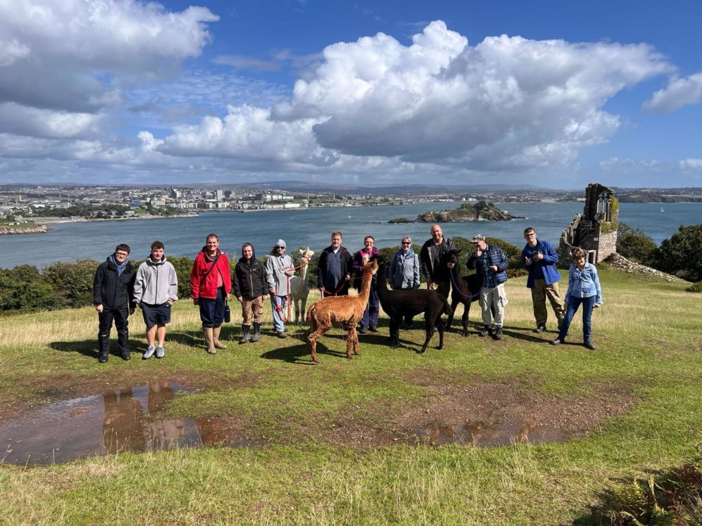 a photo of the group with llamas